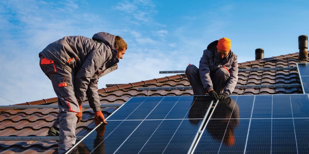 Solar panels and installers on roof