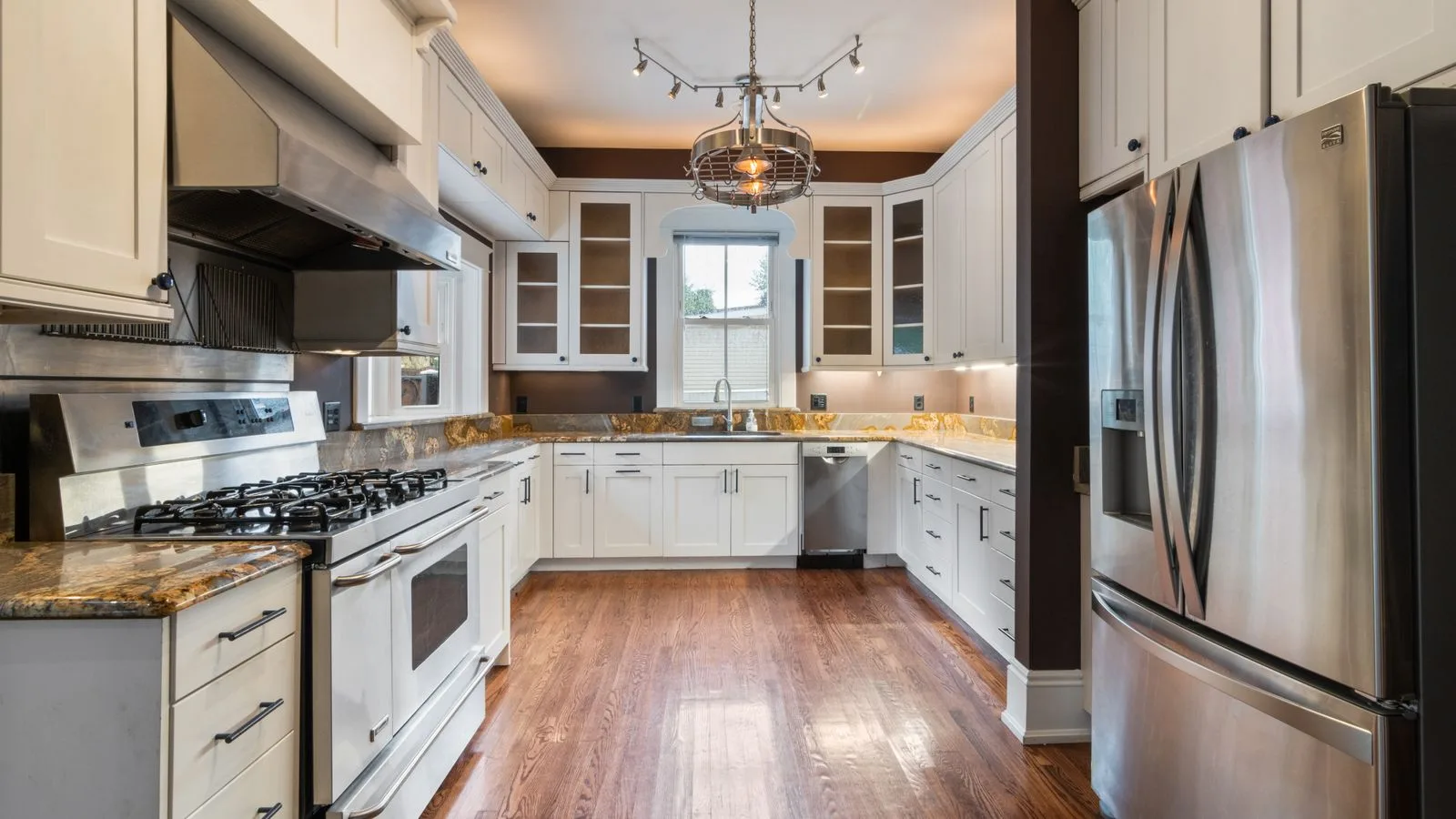 Home kitchen with stainless steel appliances and granite countertops