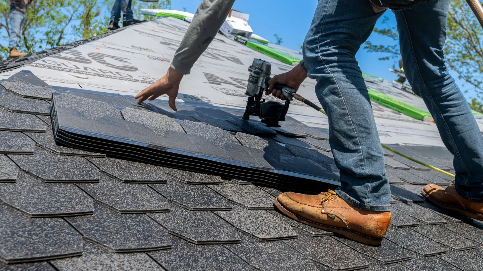 Roofer installing asphalt shingles on a Florida home roof