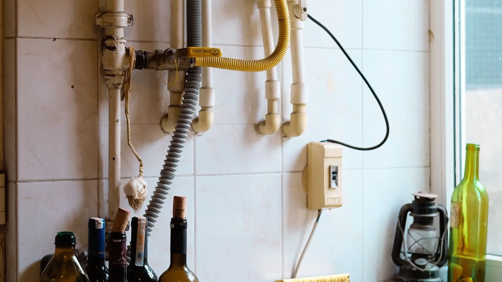 Water heater supply pipes and plumbing connections in a utility space